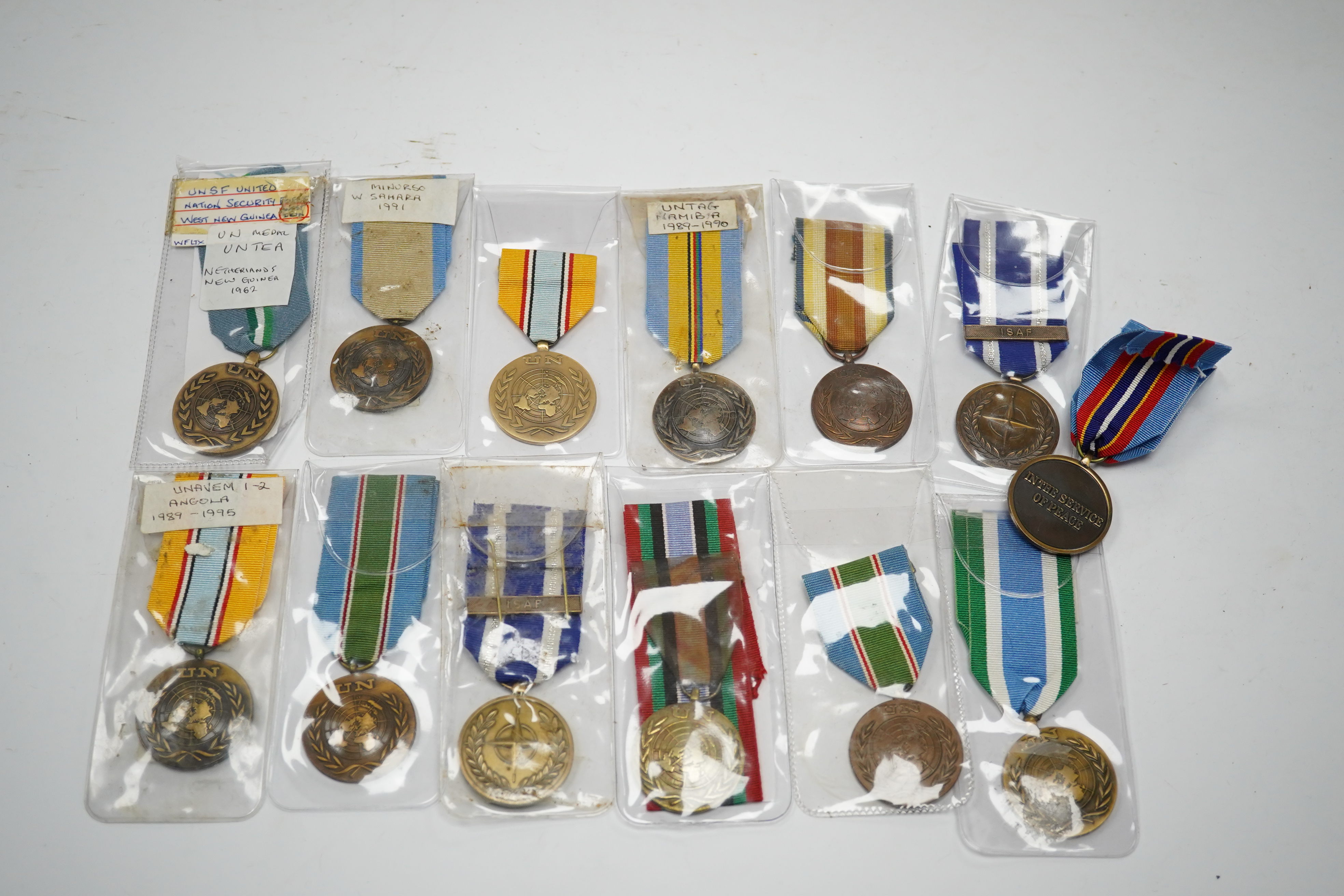 Thirteen United Nations (UN) and NATO medals, eleven UN examples with ‘ in the service of peace’ to the reverse, including a variety of ribbons for a number of different campaigns, (some duplicates), and two NATO ISAF Af